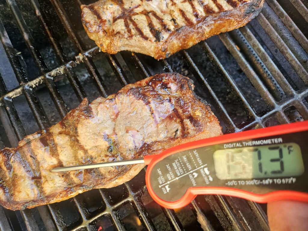 Checking steak temperature with the Alpha Grillers instant-read thermometer.